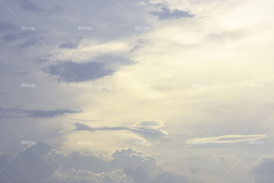 The beauty of the sky with clouds and the sun in summer.