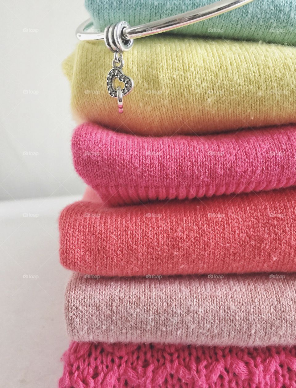 Stack of towels with bracelet