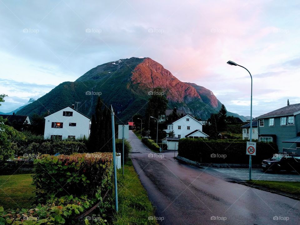 little village under the sunset over the mountain