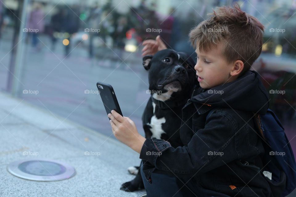 walking the dog down the street, the owner walks the weakling, teaches her, cleans up after her, educates, plays with his pet. people and dogs are best friends