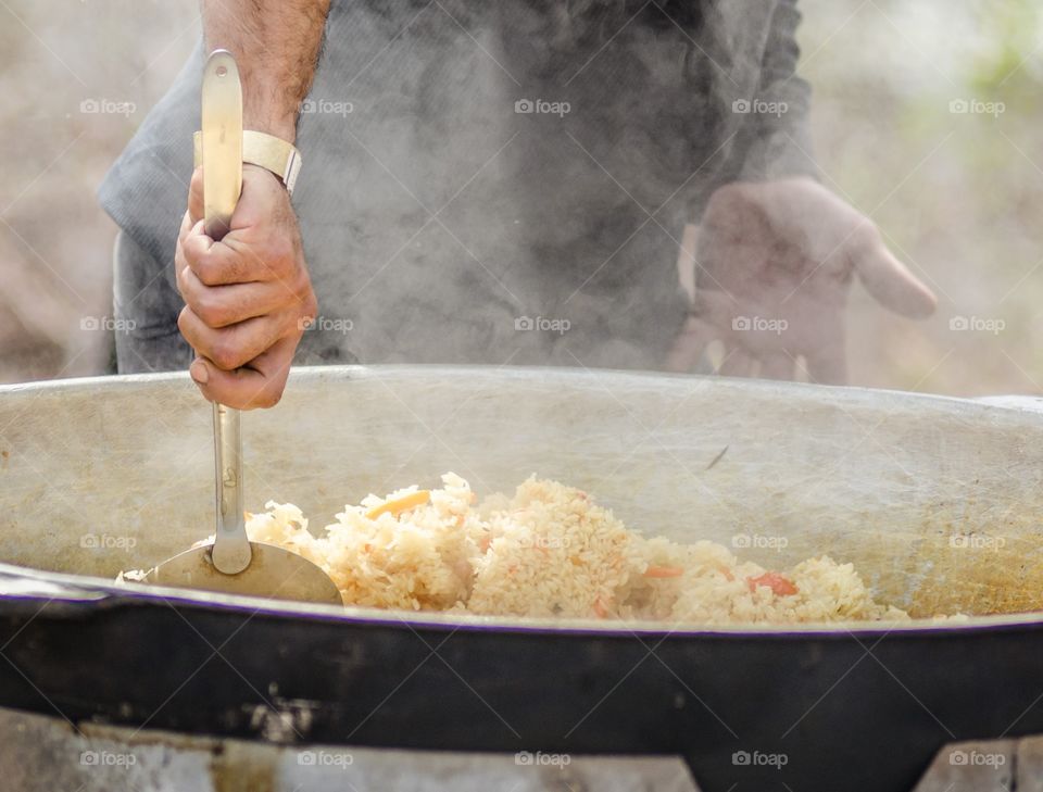 Person preparing rice dish