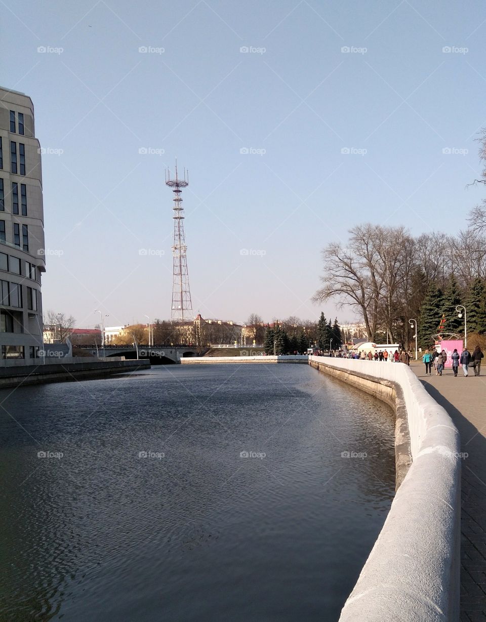 cityscape river shore and people walk