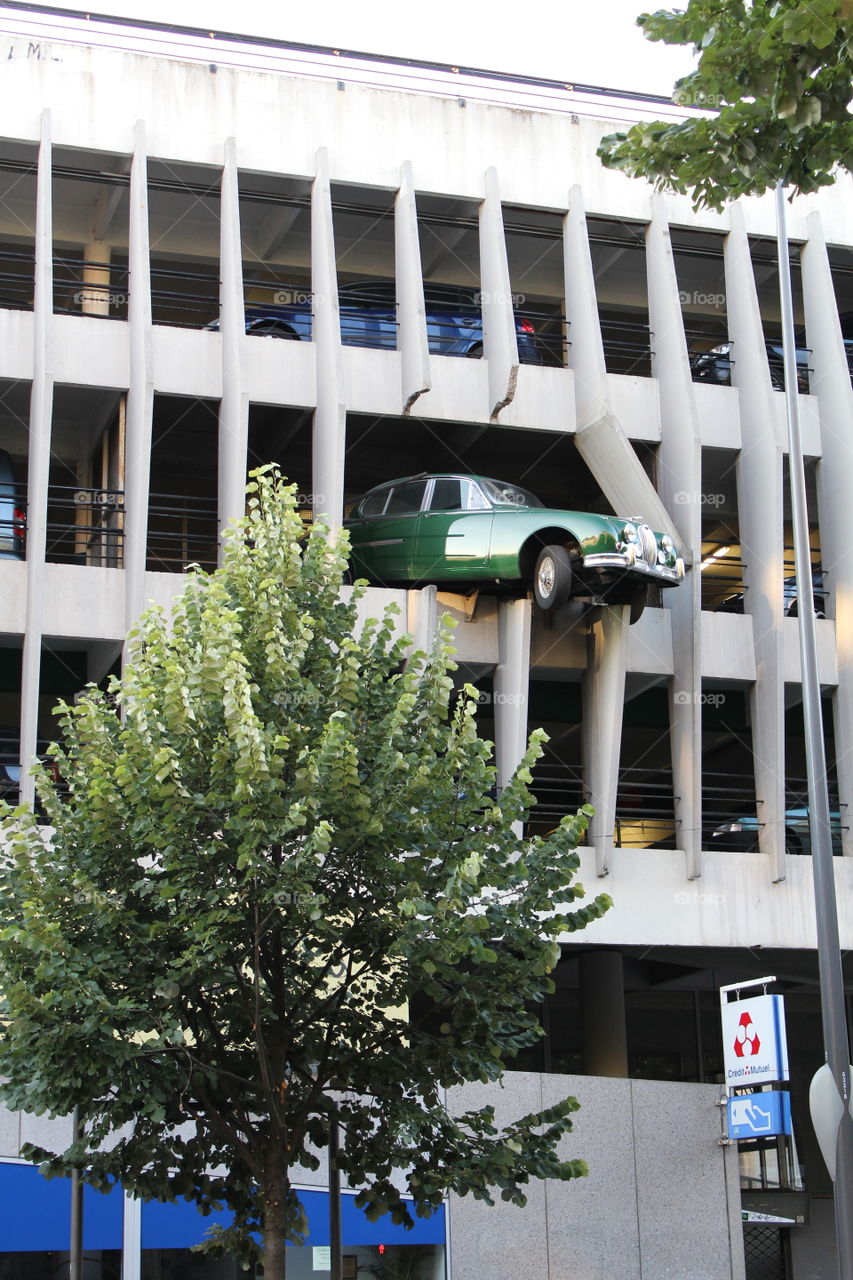 Car breaking out of a multi level parking lot. Awesome piece of art in Bordeaux, France.