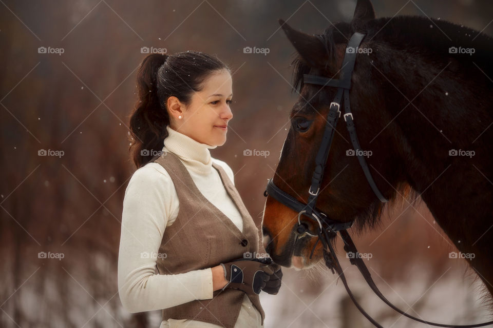 Young beautiful woman with horse outdoor portrait at spring day