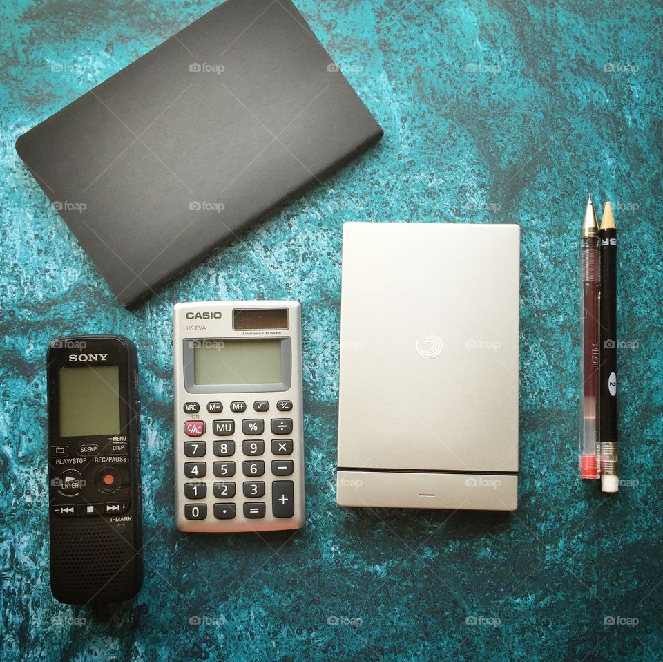 Office Desk tools. Desk tools like recorder, diary, backup hard drive, pens  