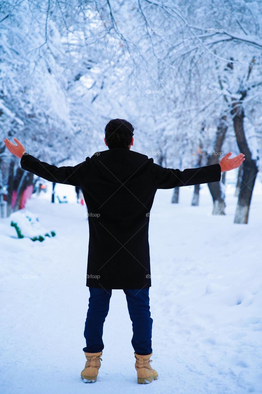 Standing in white snow path with beautiful trees 