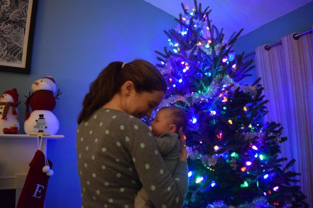 Mom and her baby enjoying the glow from the Christmas lights 