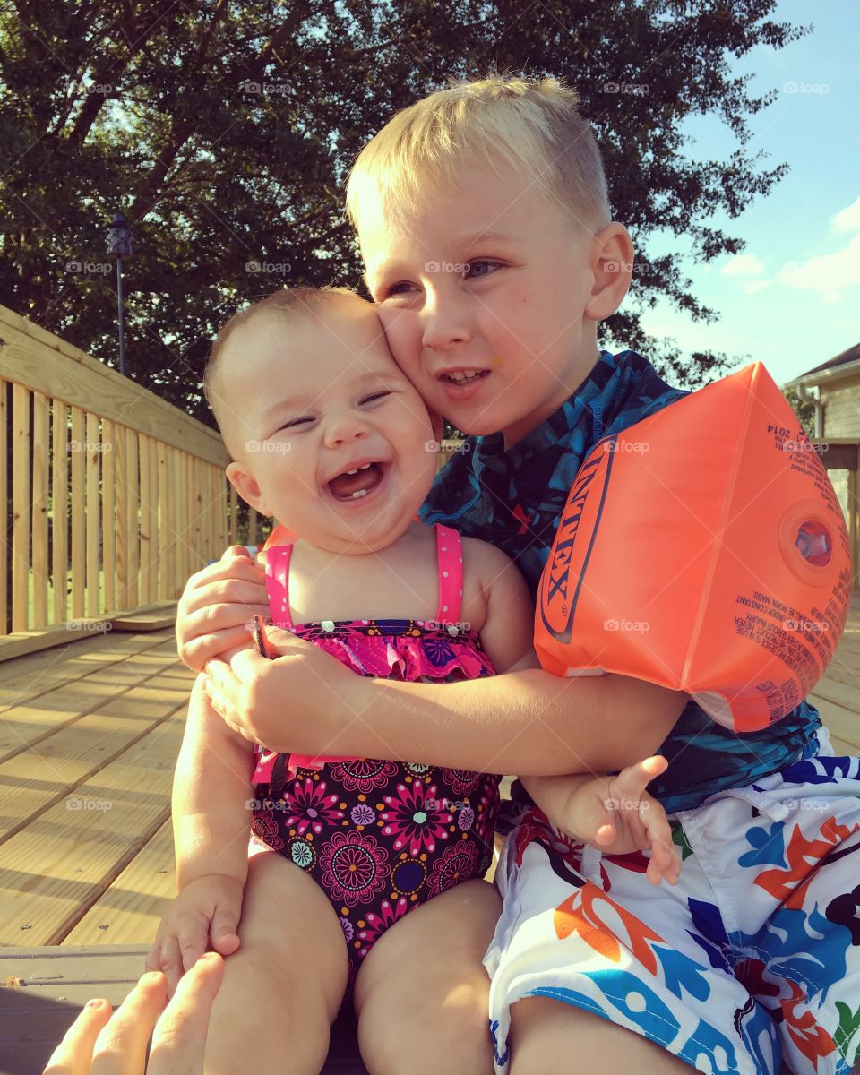 Brother holding his little sister