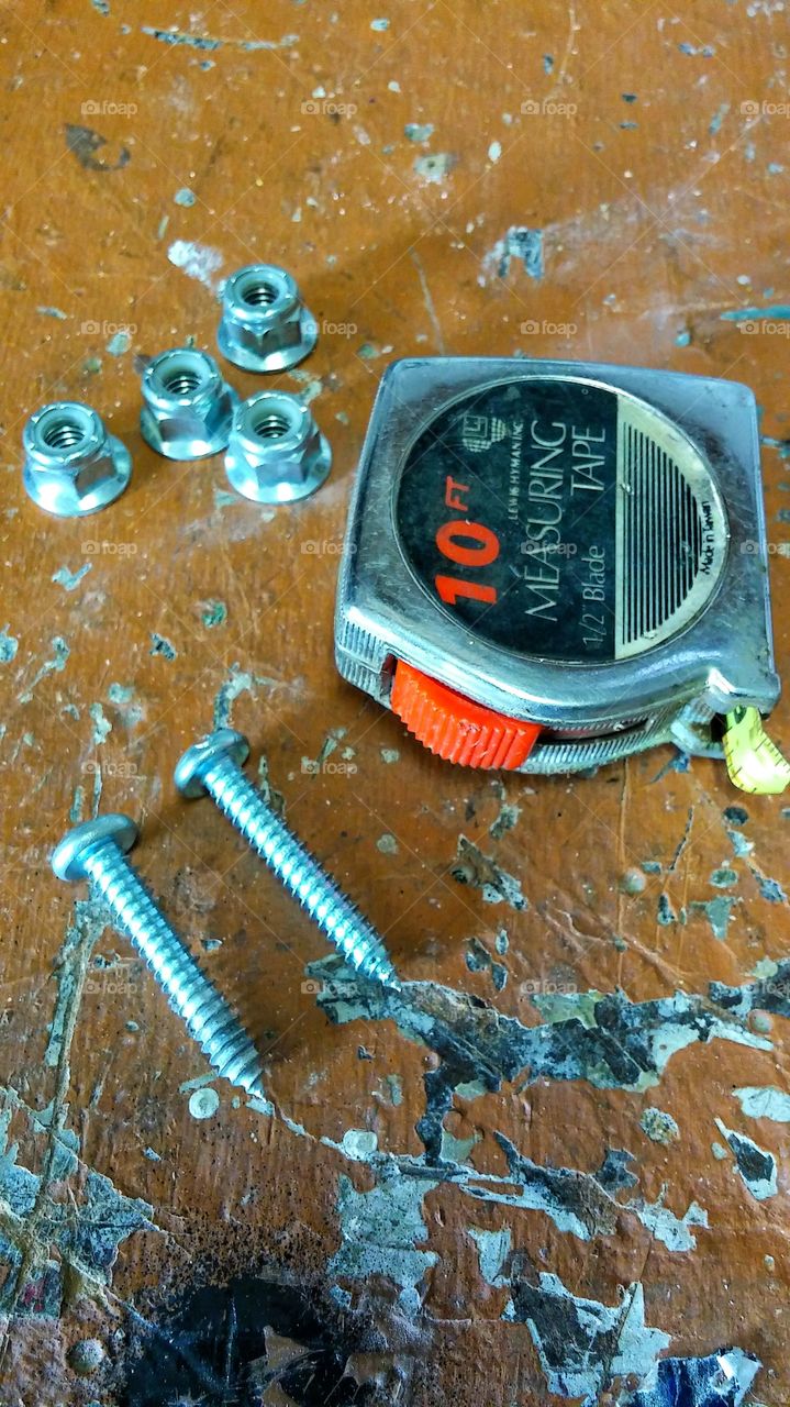 old - rusty - broken - tape measure - nuts - screws - workbench!