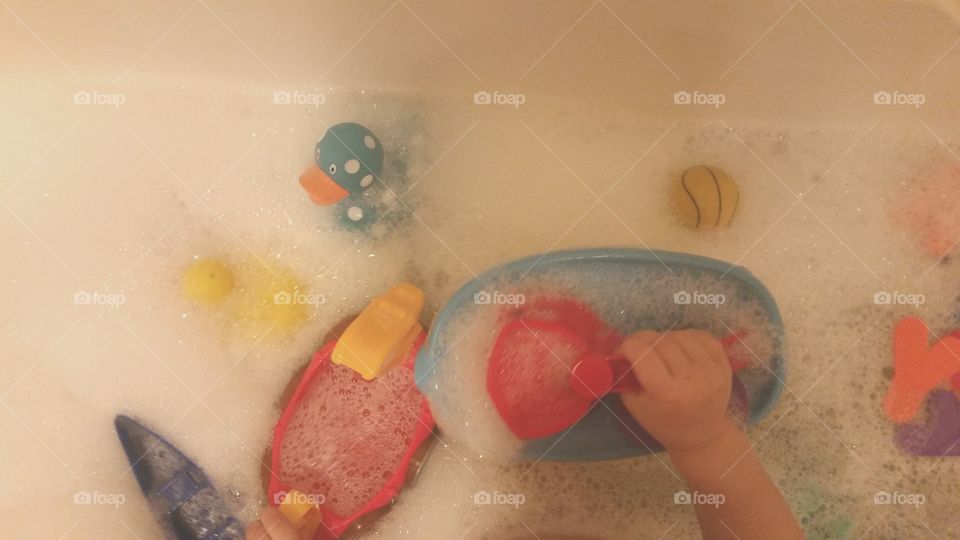 bubbles and toys in the bath tub