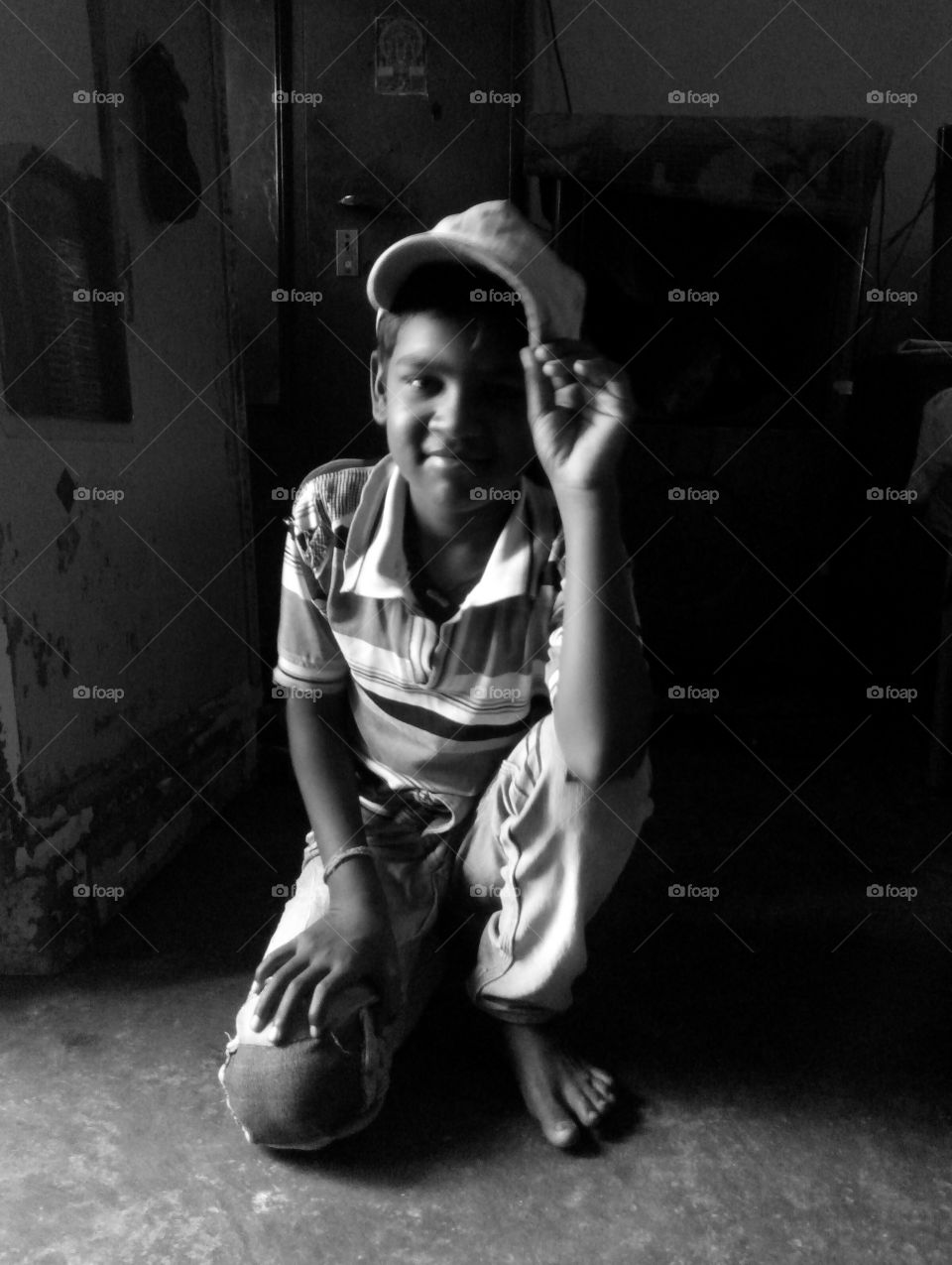black and and white pics/one kid/single kid/indian kid/kid with smlie/kid with cap/light and shade pics/kid in home