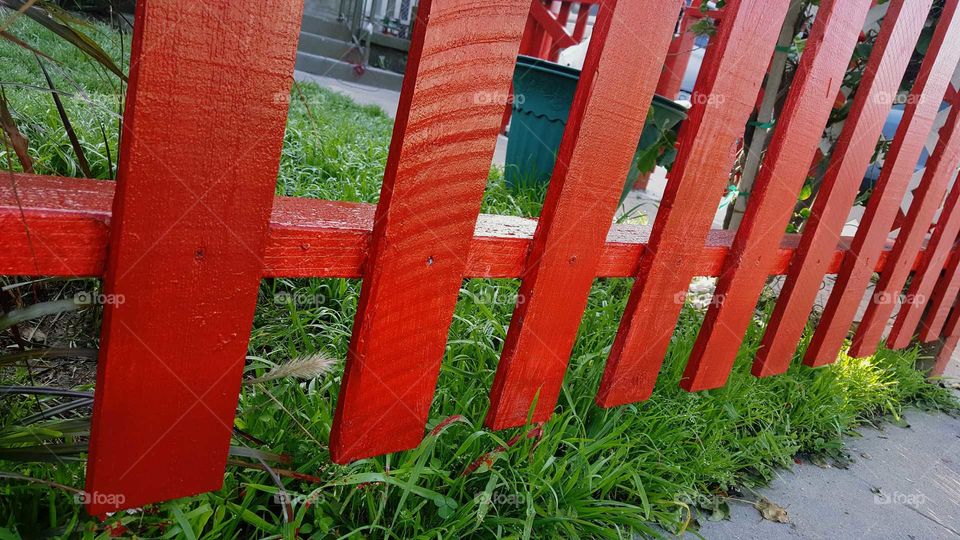 Red Fence with Green Grass