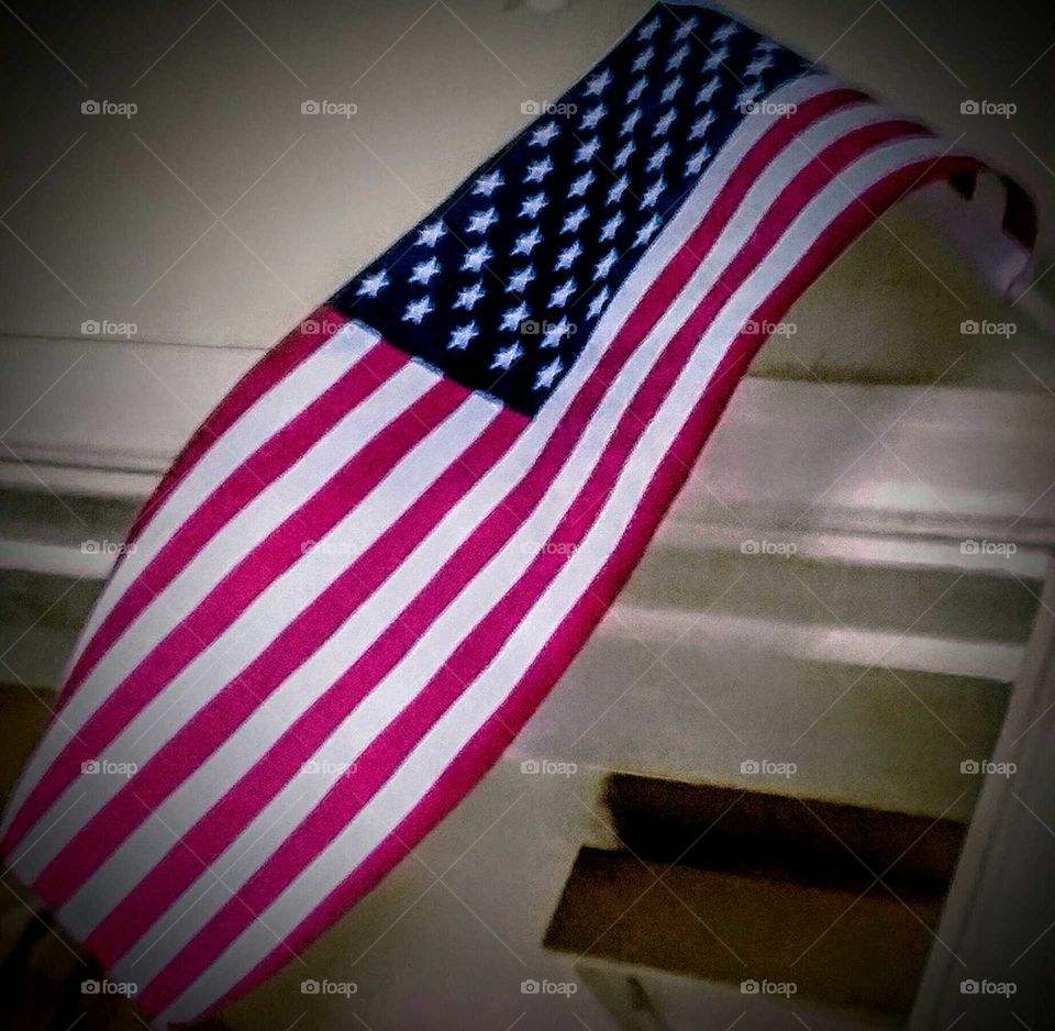 American Flag Diagonally Placed in Arch on Porch