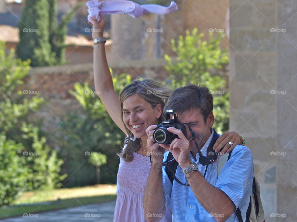 Happy couple taking photograph with camera