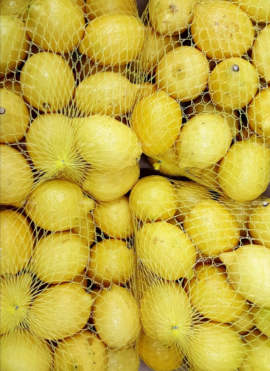 Lemons packed in yellow net