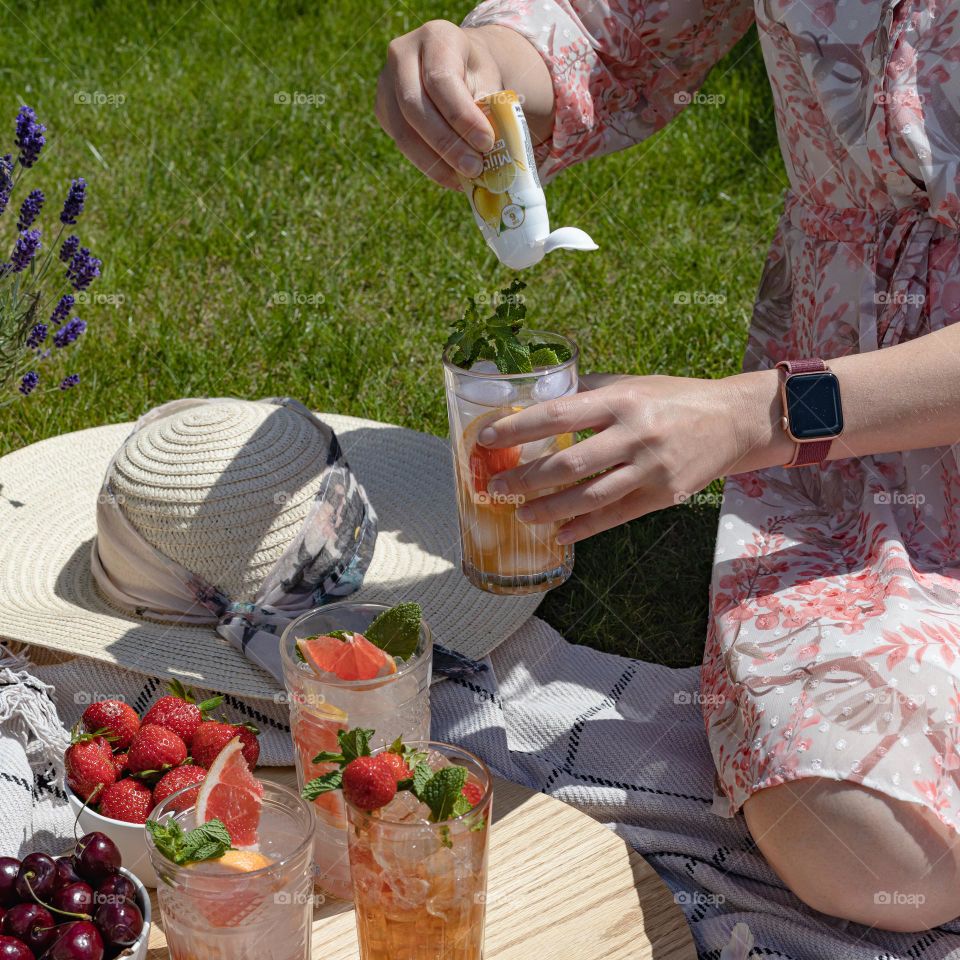 Summer picnic, girl preparing lemonade
