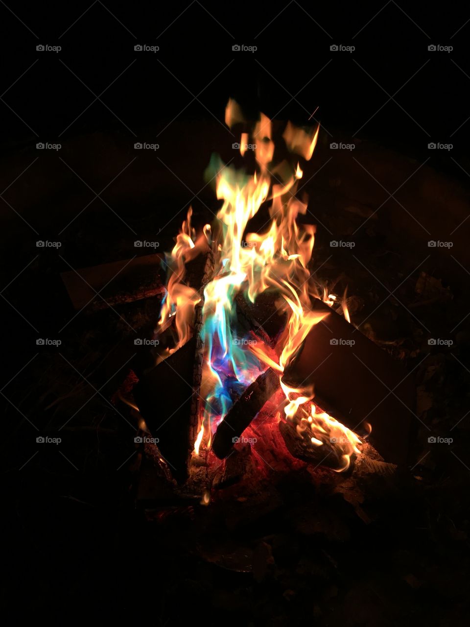 Mystic fire . Colorful backyard with flames of blue green red yellow orange