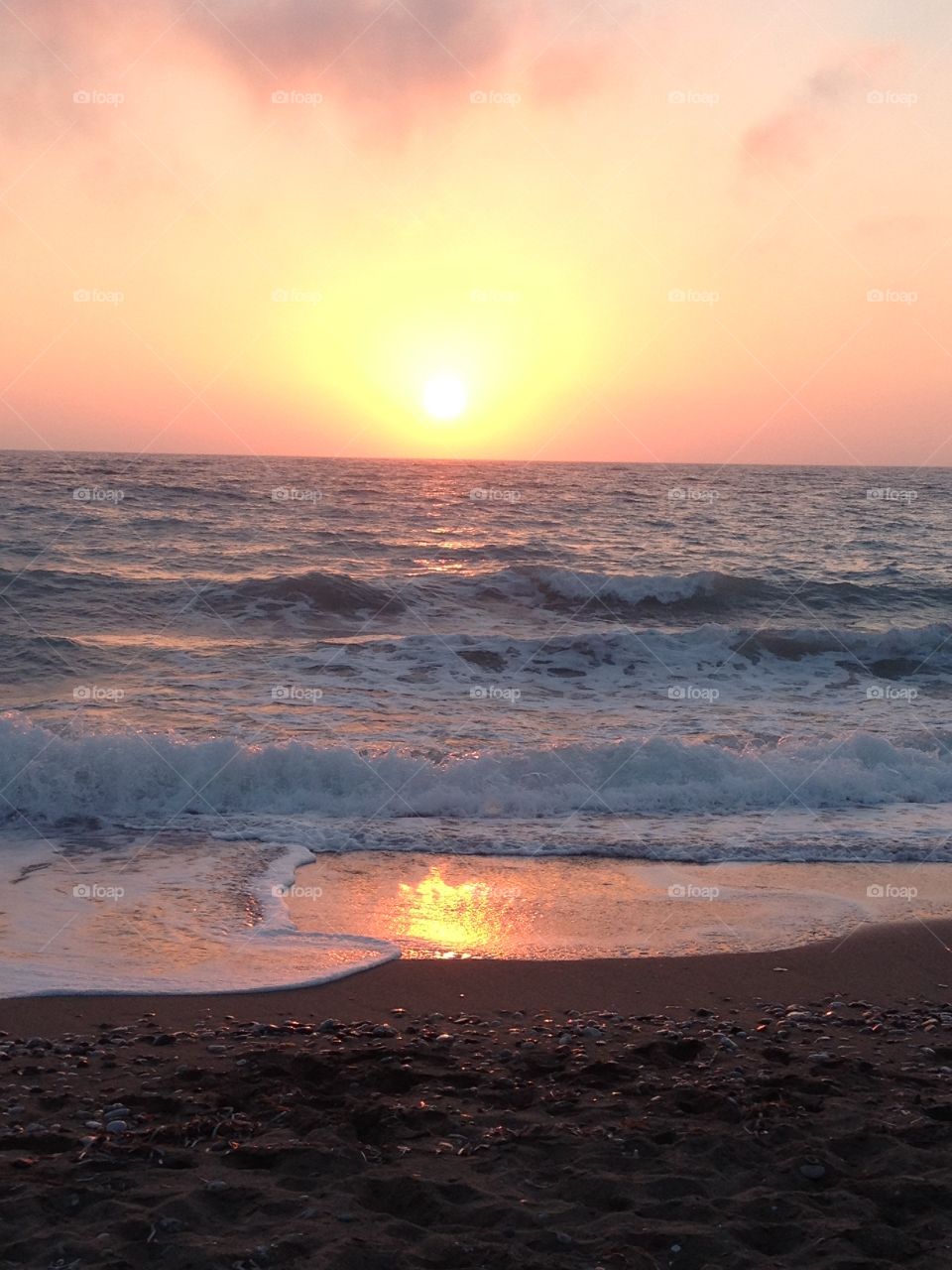 A beautiful sunset over a beach in Rhodes, Greece