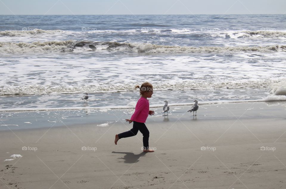 girl running at the beach. hilton head island