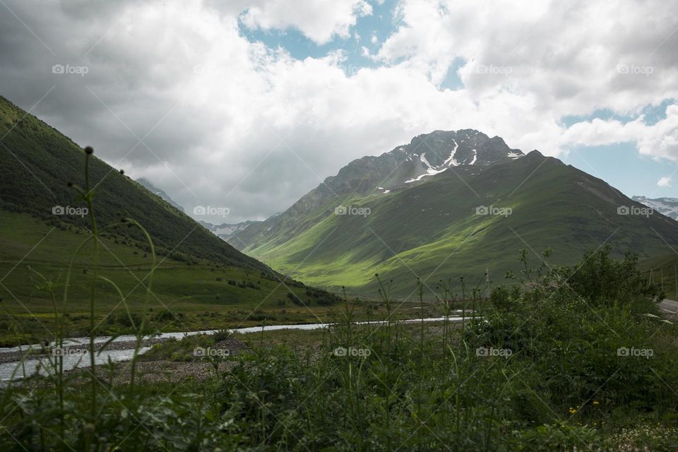 Green mountain and cloudy sky