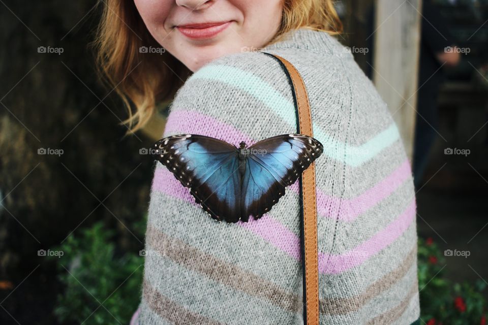 A brief meeting, nature’s kiss given by the most royal of butterflies, frozen in time. If one looks close enough, two smiles can be spotted 