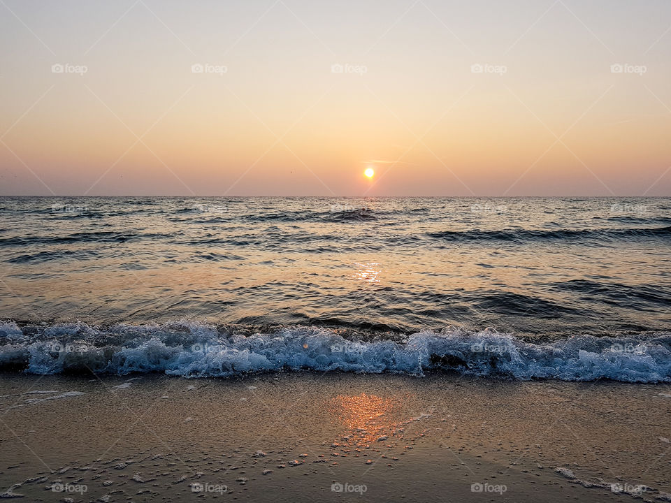 Surf at beach during sunset