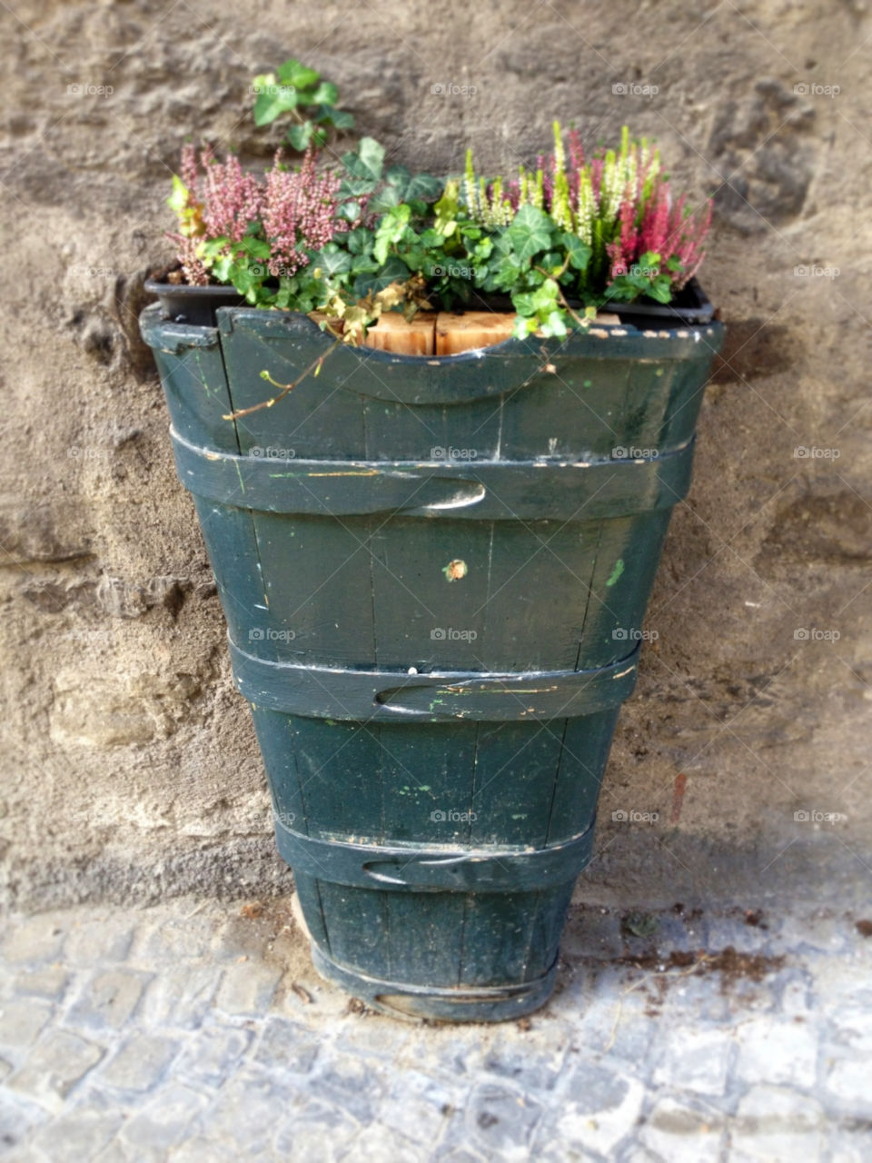 flowers put into a special box which is used to pick up grapes to be carried to the wine cellar against a wall at the wine cellar lutry by swisstraveler