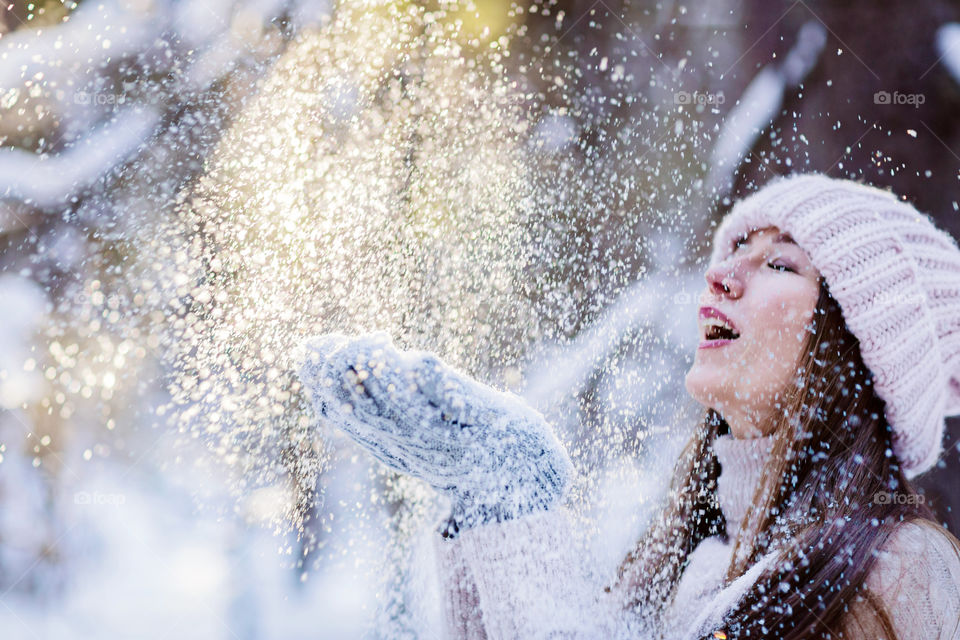 Happy woman in snowy forest