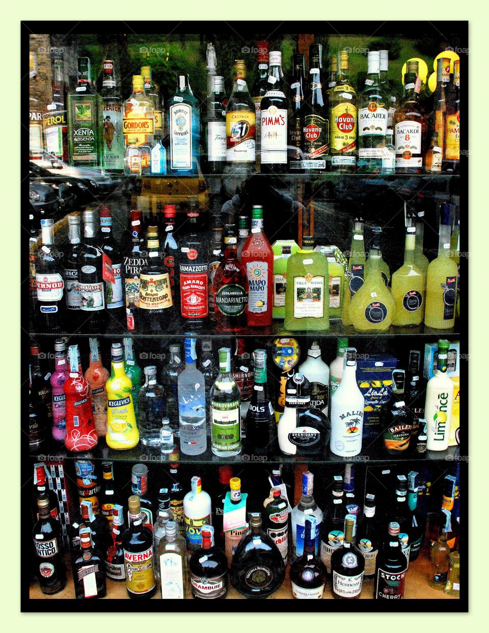 Candy is dandy. A beautiful collection of liquor bottles in a window in Italy