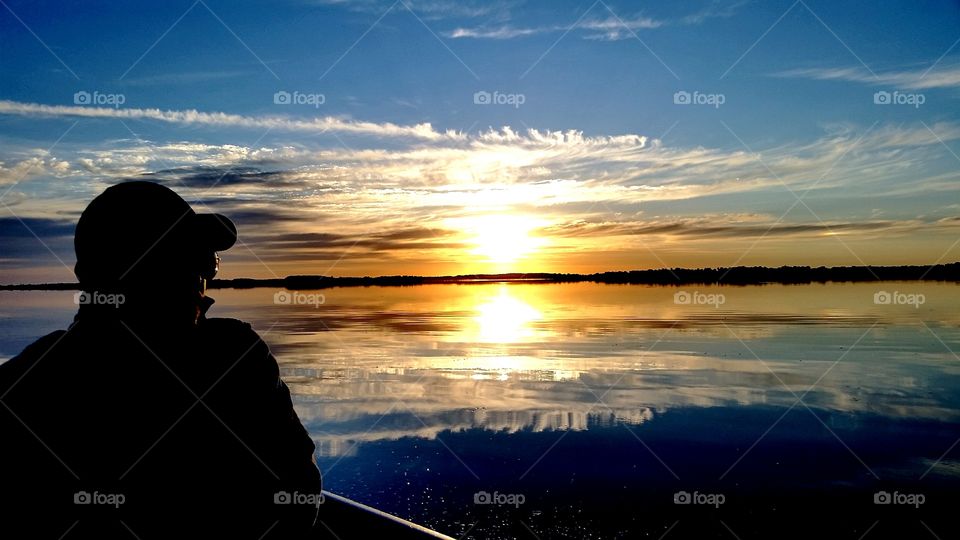 incredible sunsets with a man on a boat