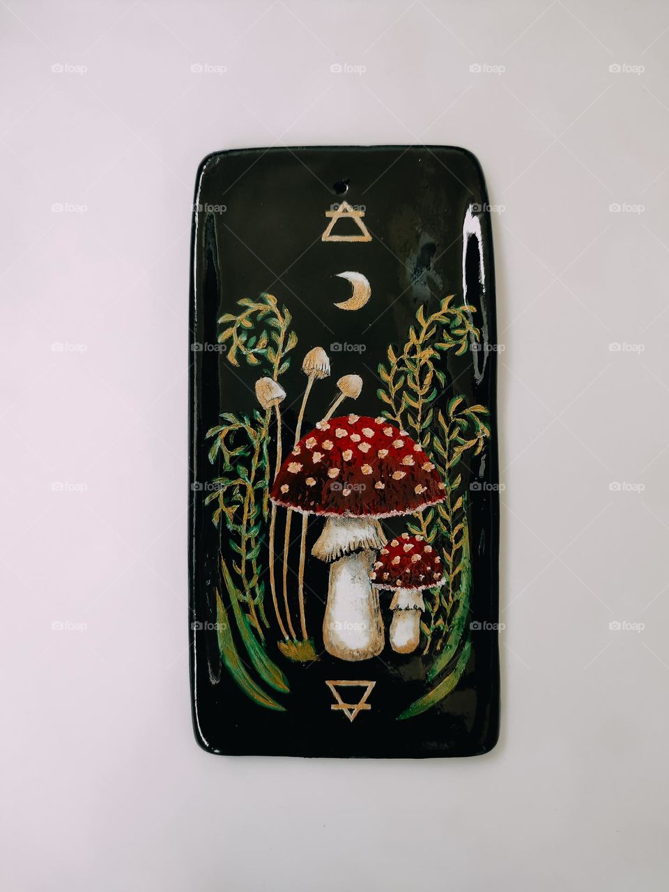 Black ceramic aroma sticks stand with pair of red amanita muscaria mushroom, mystical symbols, witchcraft, painting