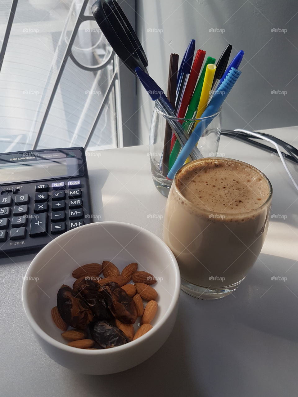Different pen colours, black from the keyboard, and different colours in the bowl and the coffee.