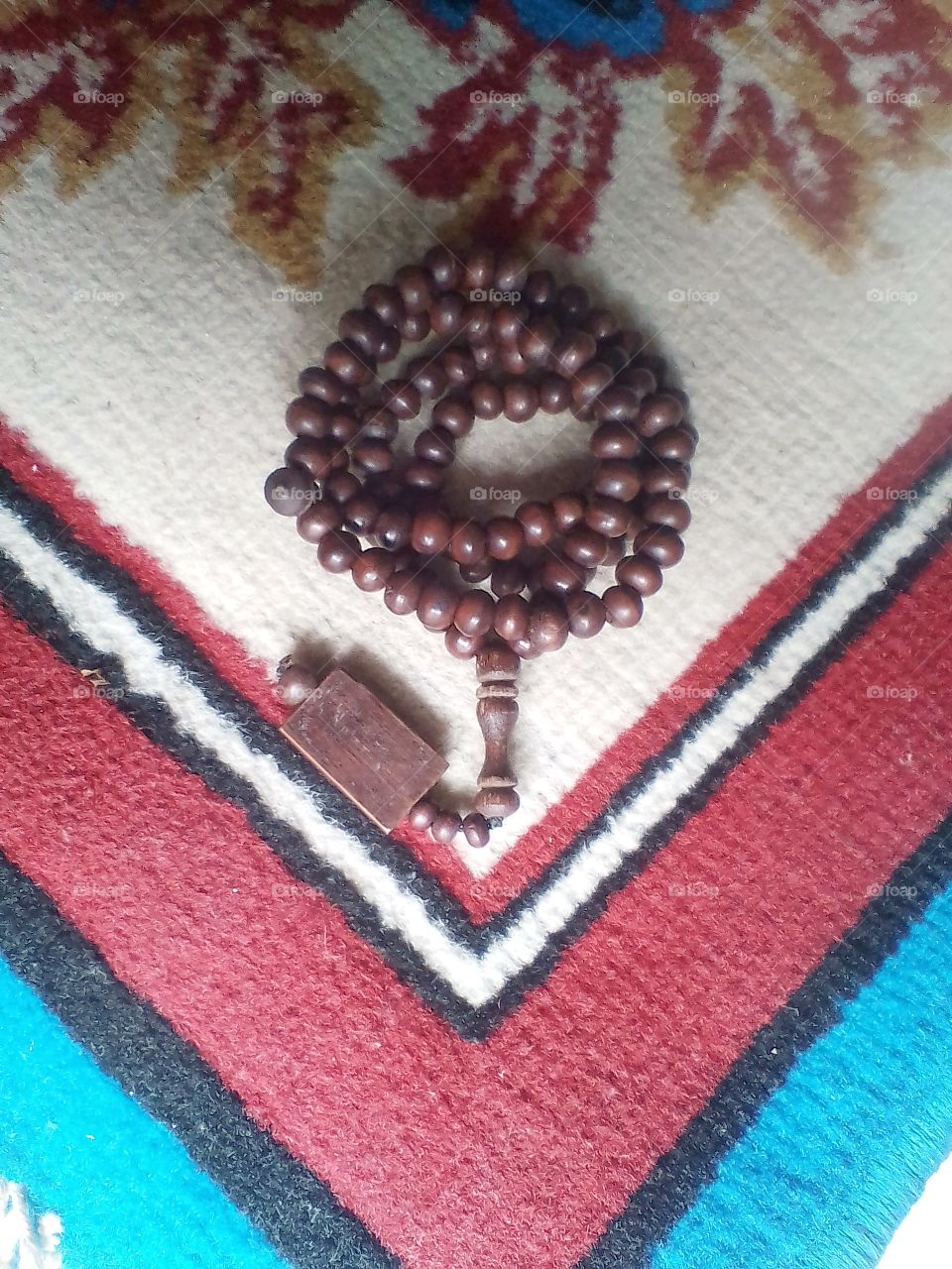 A rosary lay on the carpet