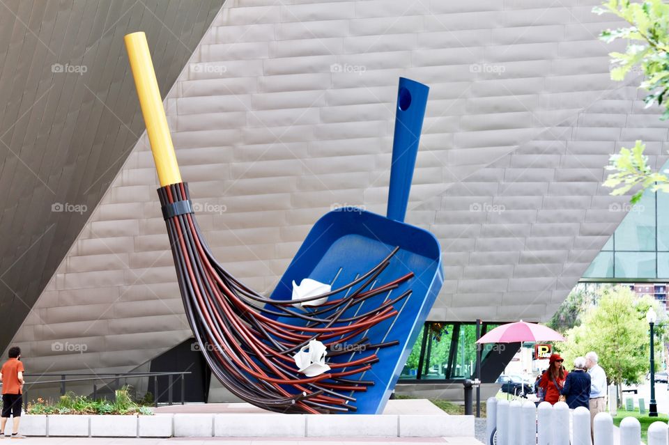 Large metallic broom and dustpan sculpture in front of the Art Museum in Denver, Colorado