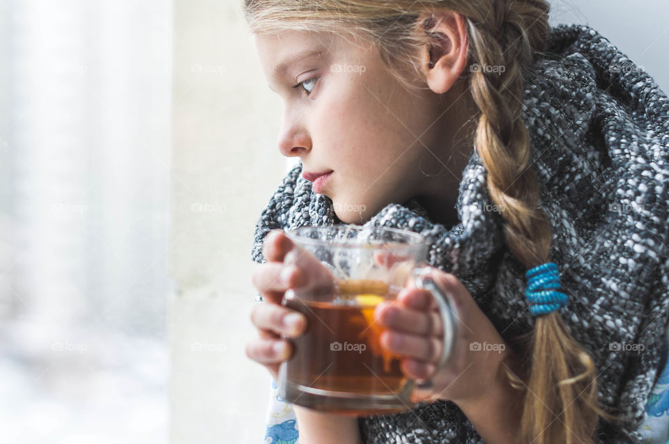 girl with hot tea trying to get warm