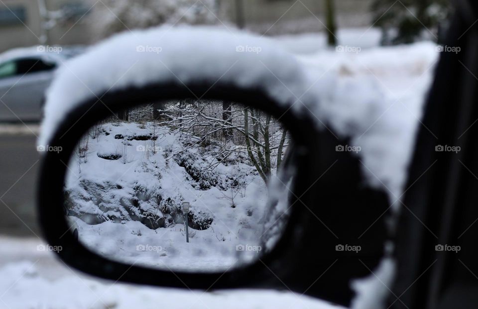 Winter view through car mirror