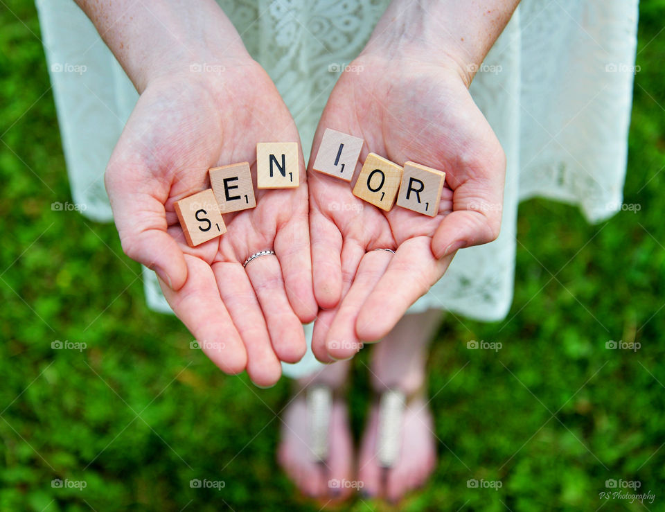 Female hand holding blocks with the word senior