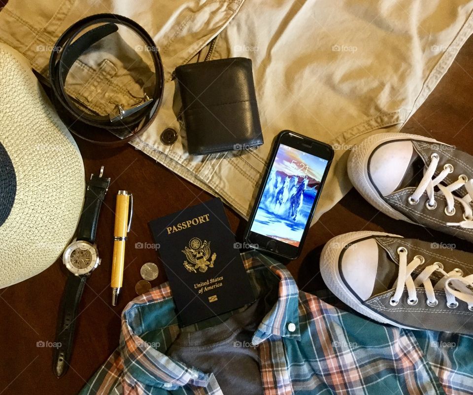 Getting ready to travel on a trip or vacation with the essentials passport phone and wallet 