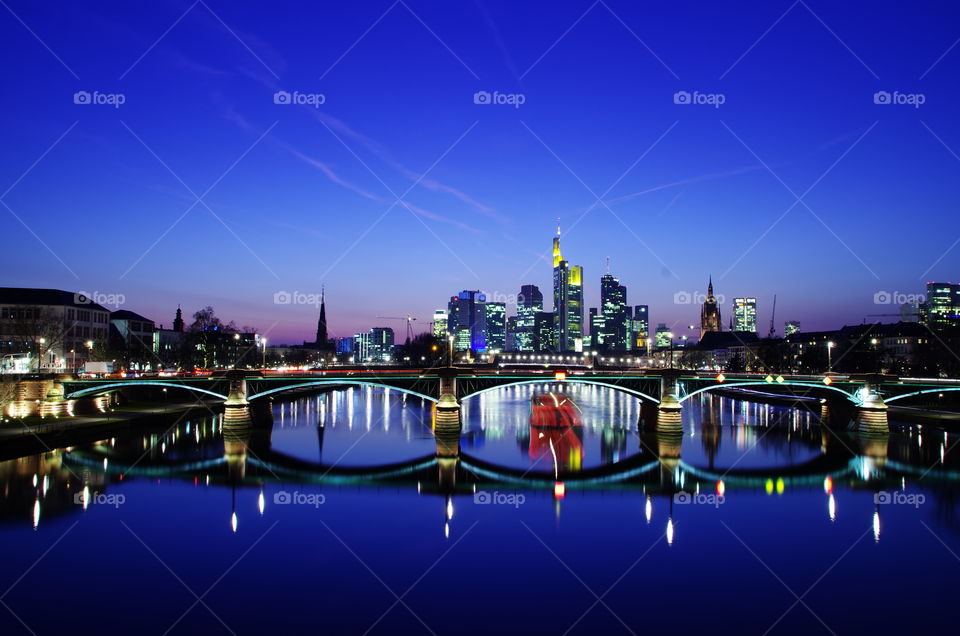 Reflection of skyline and bridge on main, Germany