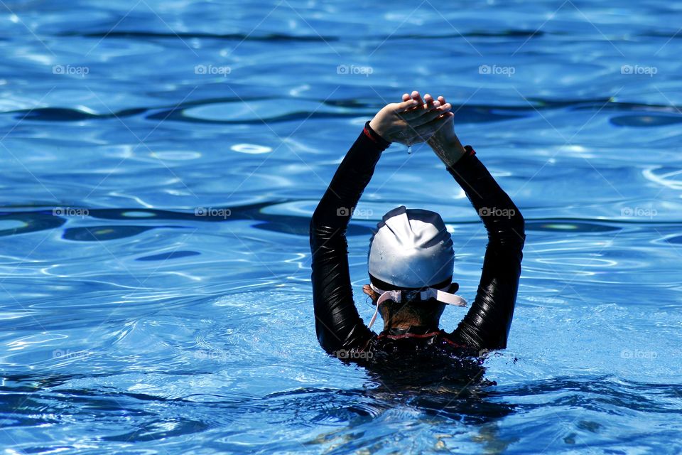 young kid prepares to swim in a swimming pool