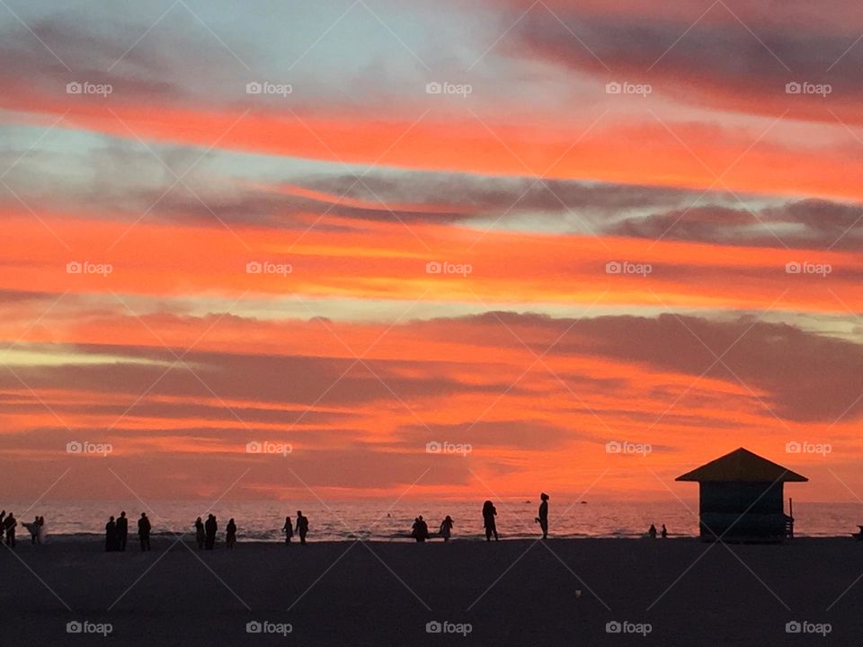 Sunset silhouette of people at the beach