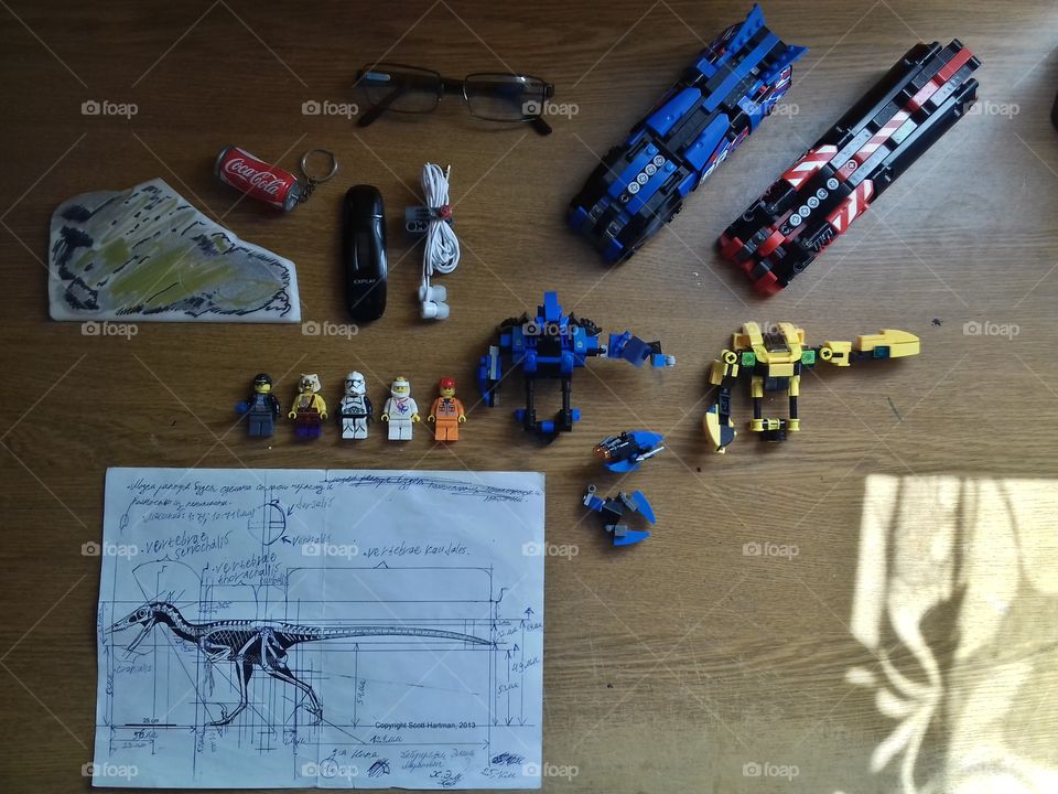 My worktable with LEGO official minifigures, my MOCs: two trains and robots, Veliciraptors sketch, MP3 player, glasses and unique art on the penoplaste