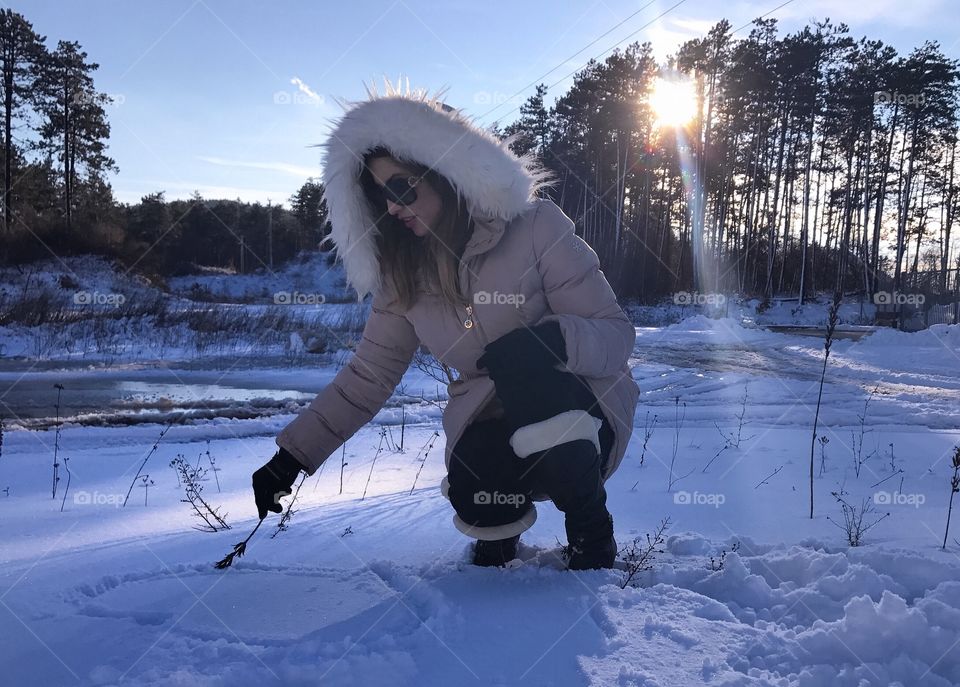Woman making heart in snow