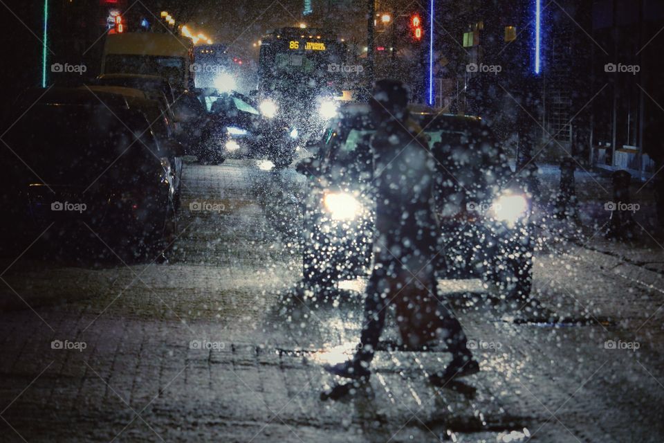 Man Walking in a city while a storm 