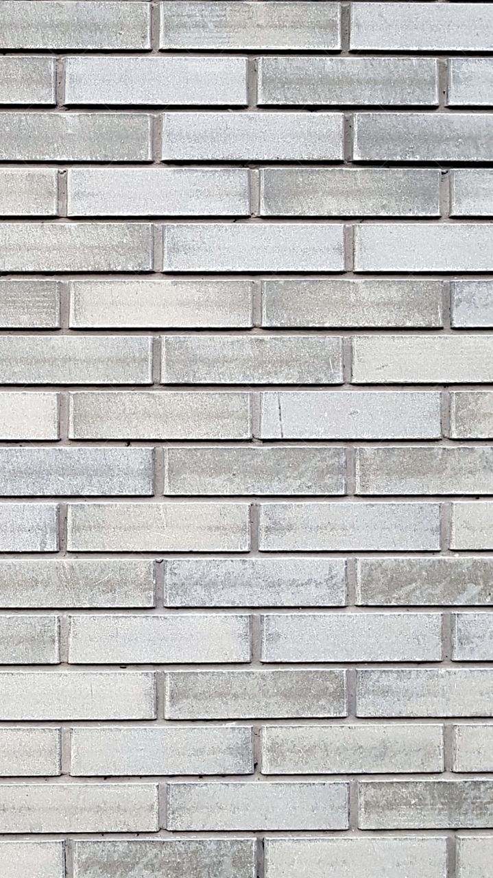 wall of white facing brick. Brickwork on cement mortar.