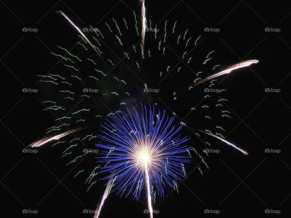 Low angle view of firework dispaly at night