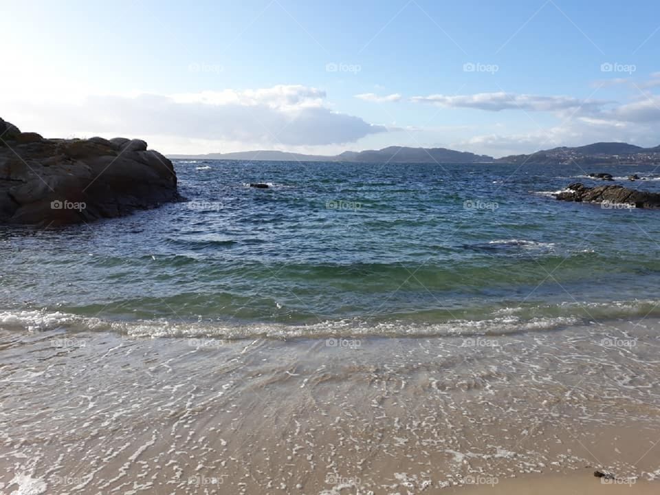 Incoming tide with rocks and greenish water