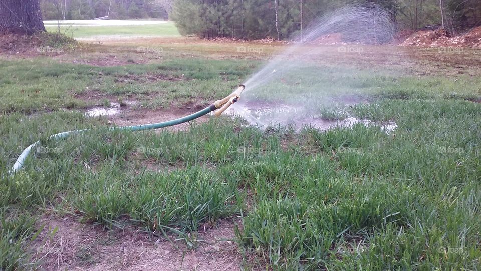 The floating hose. The water pressure gives the appearance of the hose floating and watering the lawn.