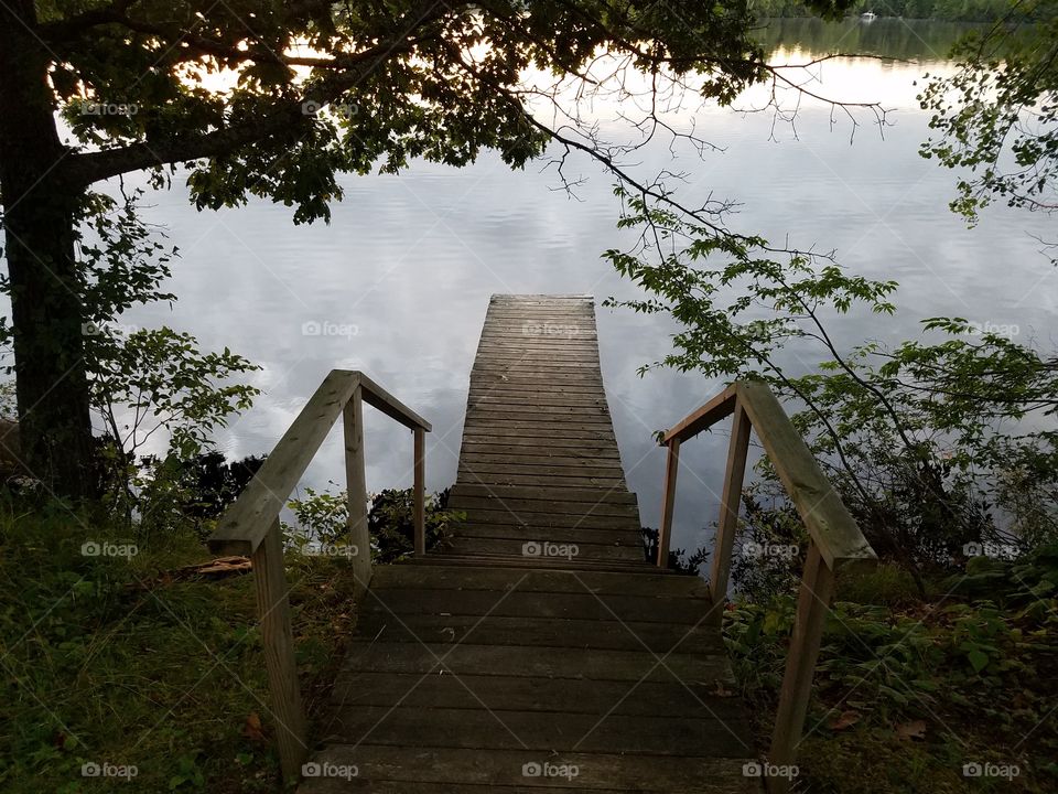 View of a pier leading towards lake