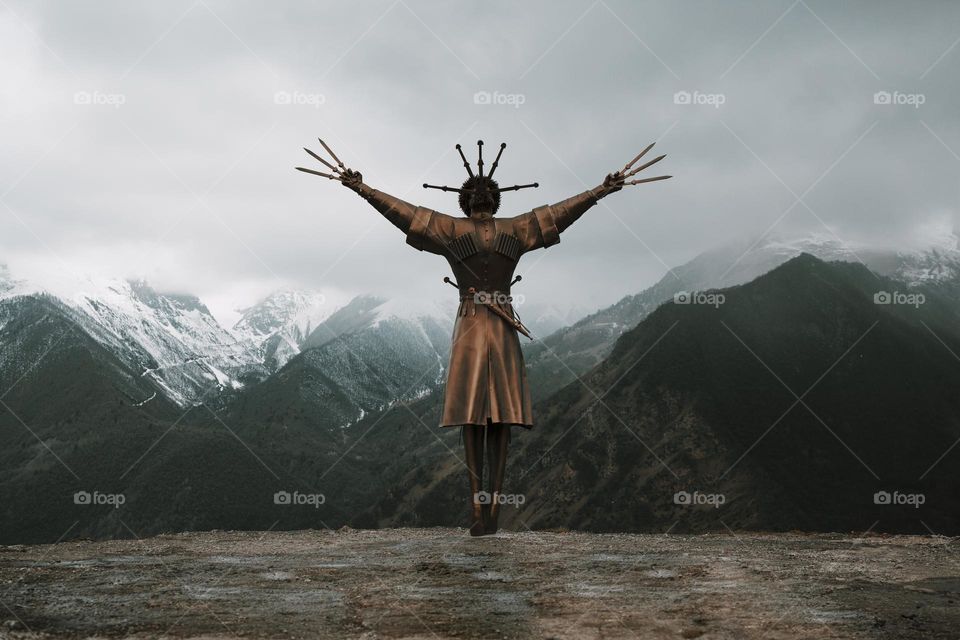 Art object Dance With Daggers against mountain landscape